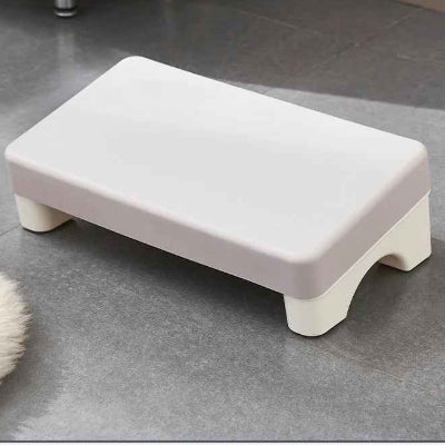 Repose pied ergonomique gris sur le sol vue rapproché